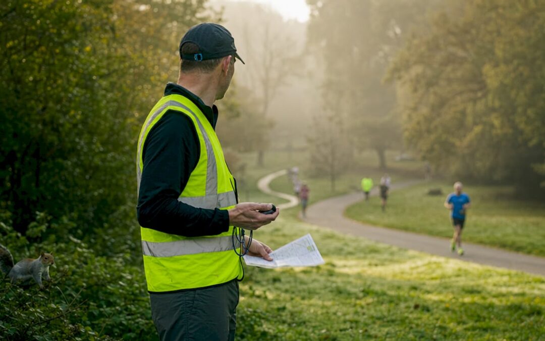 Volunteer running marshal guiding participants outdoors